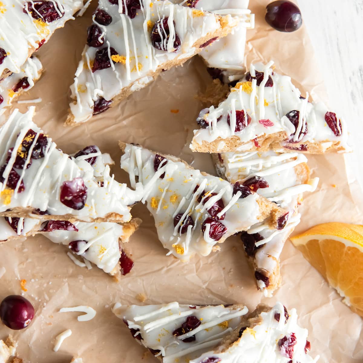 cranberry bliss bars topped with white chocolate, dried cranberries and orange zest.