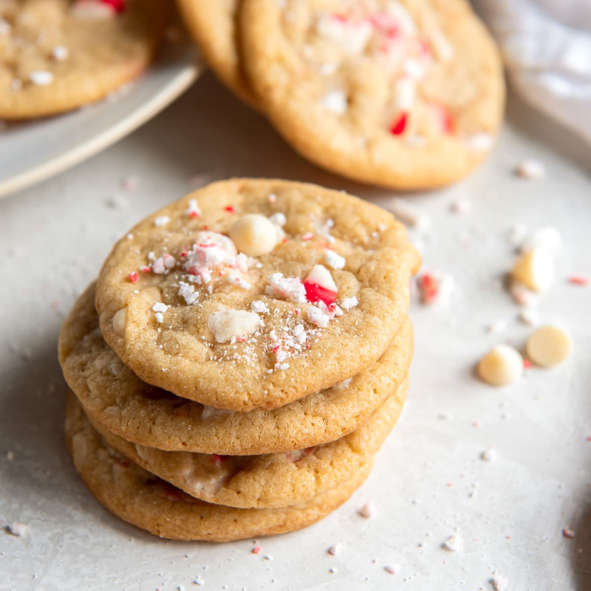 stack of white chocolate peppermint cookies with crushed peppermint on top.