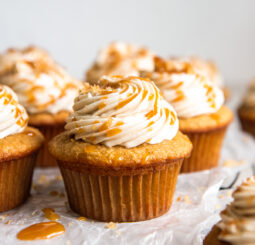 brown sugar cupcake with caramel frosting and caramel drizzled on top.