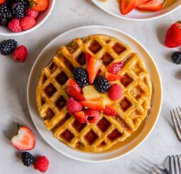 plate of buttermilk waffles topped with berries.