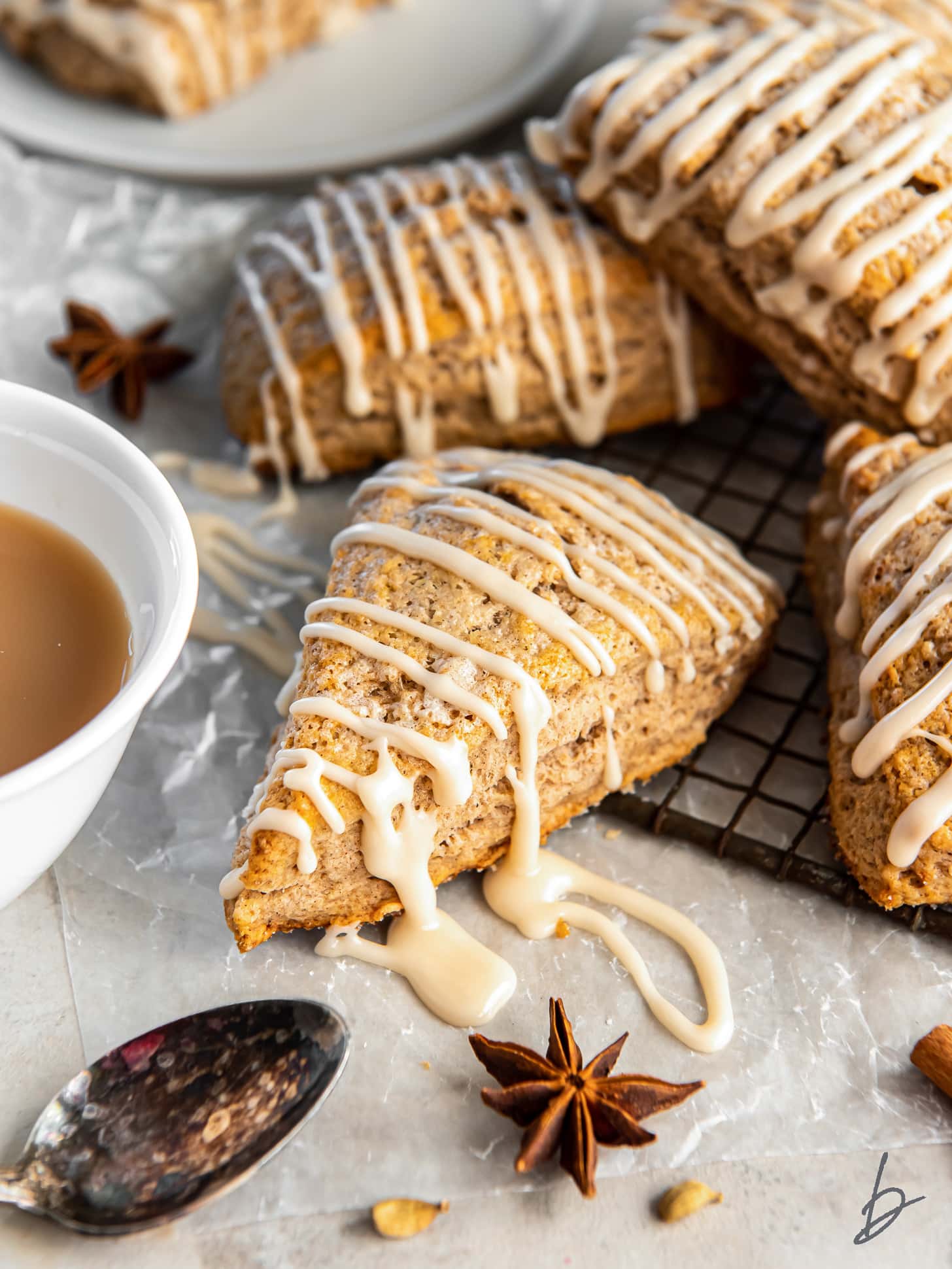 chai scone with maple glaze dripping off the side.