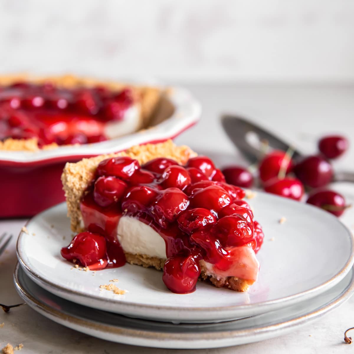 slice of cherry cream cheese pie on a plate.