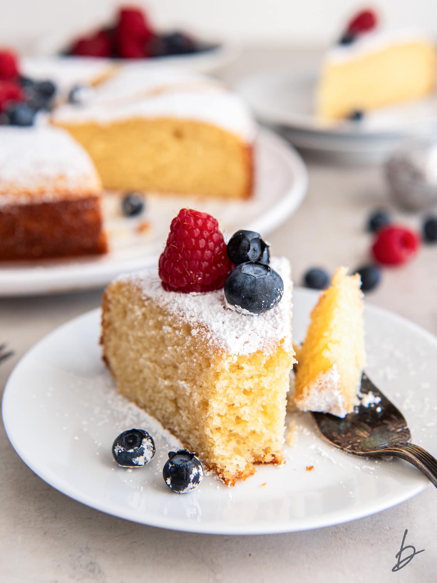 slice of irish tea cake with berries and a bite taken off of the end of the cake.