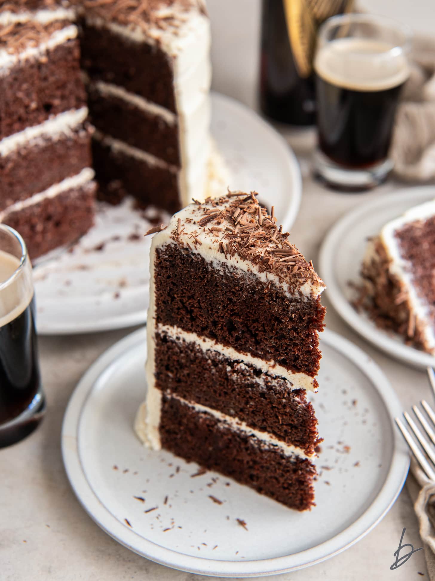 plate with slice of triple layer chocolate guinness cake with baileys frosting.