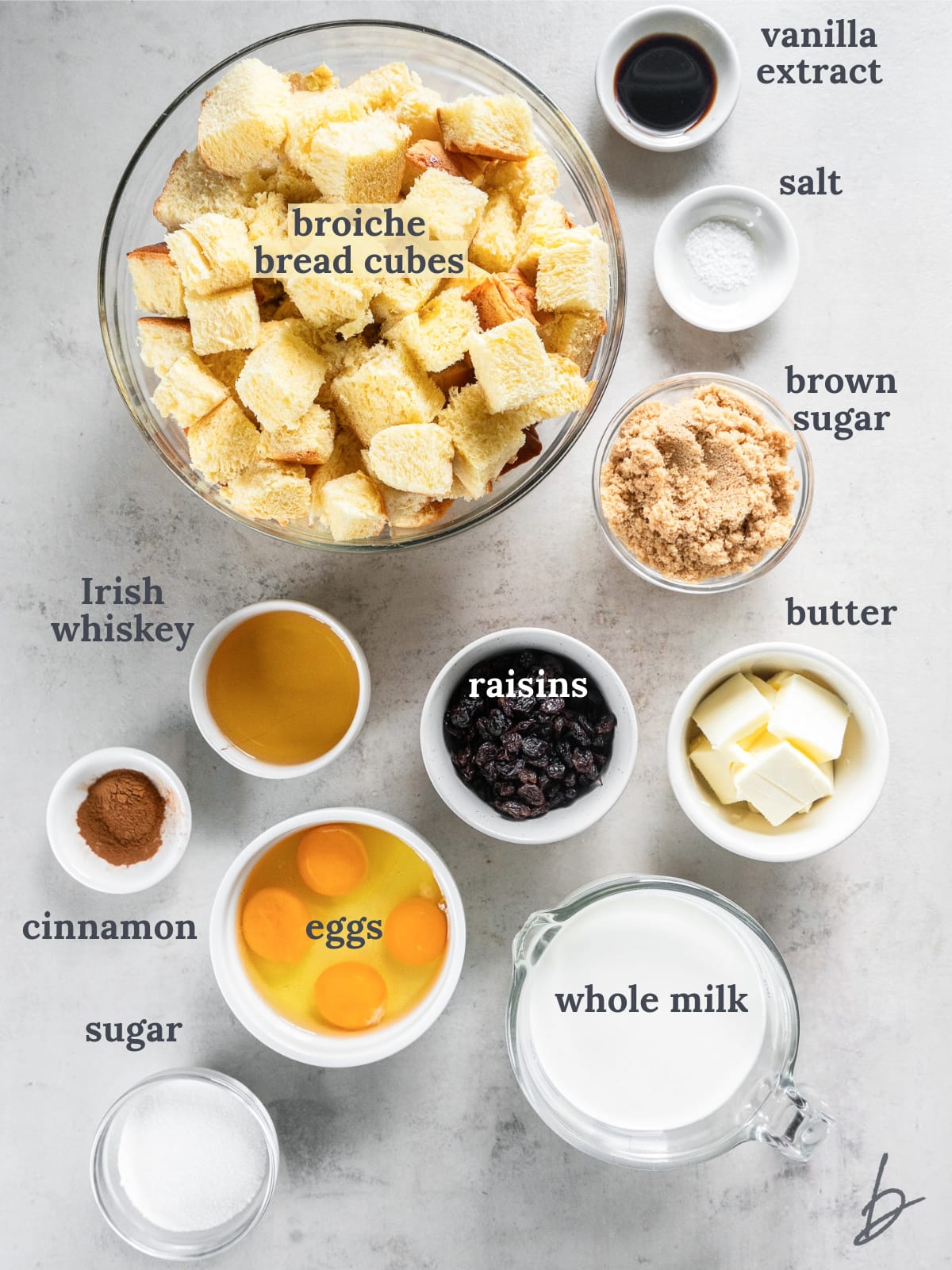 bowls of ingredients to make irish bread pudding with whiskey sauce.