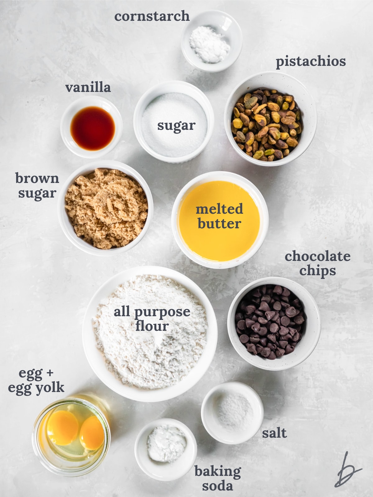 bowls of ingredients to make chocolate chip pistachio cookies.
