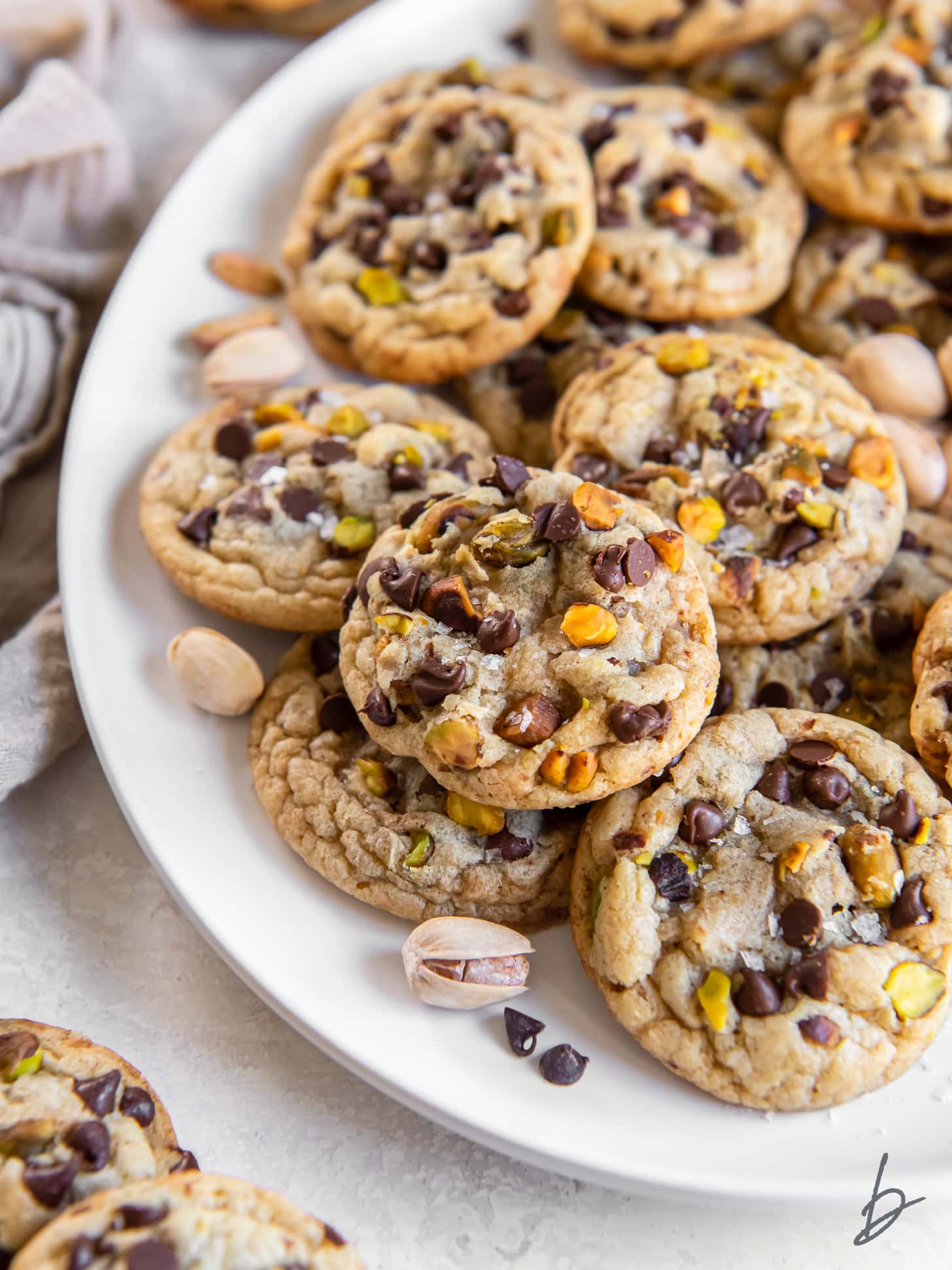 salted chocolate chip pistachio cookies on a plate.