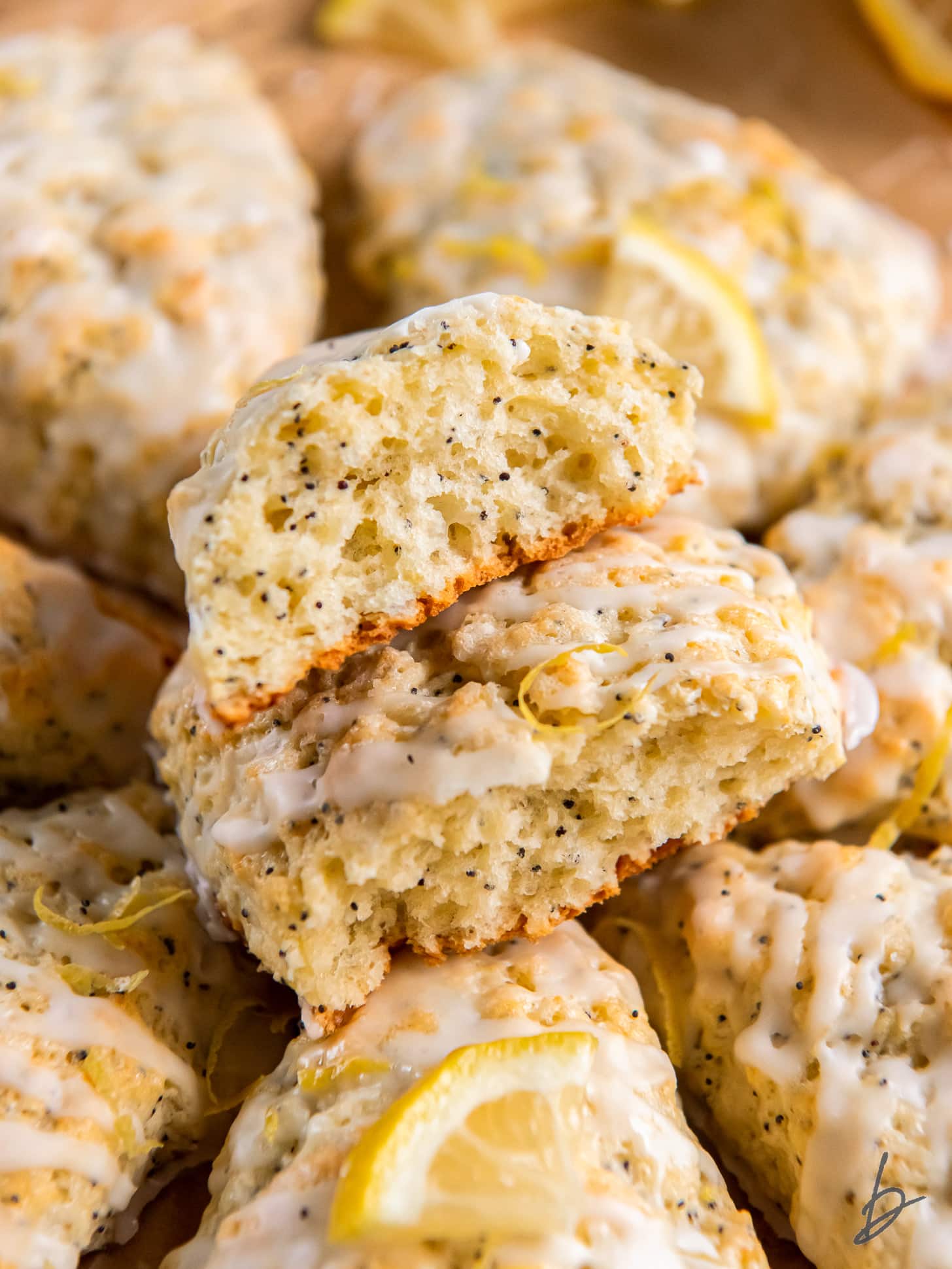 two halves of a lemon poppy seed scone stacked on top of each other showing soft and moist center.