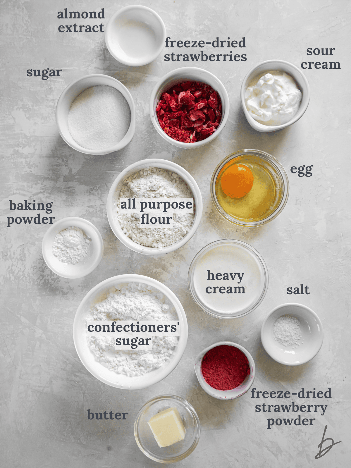 bowls of ingredients to make baked strawberry donuts with icing.