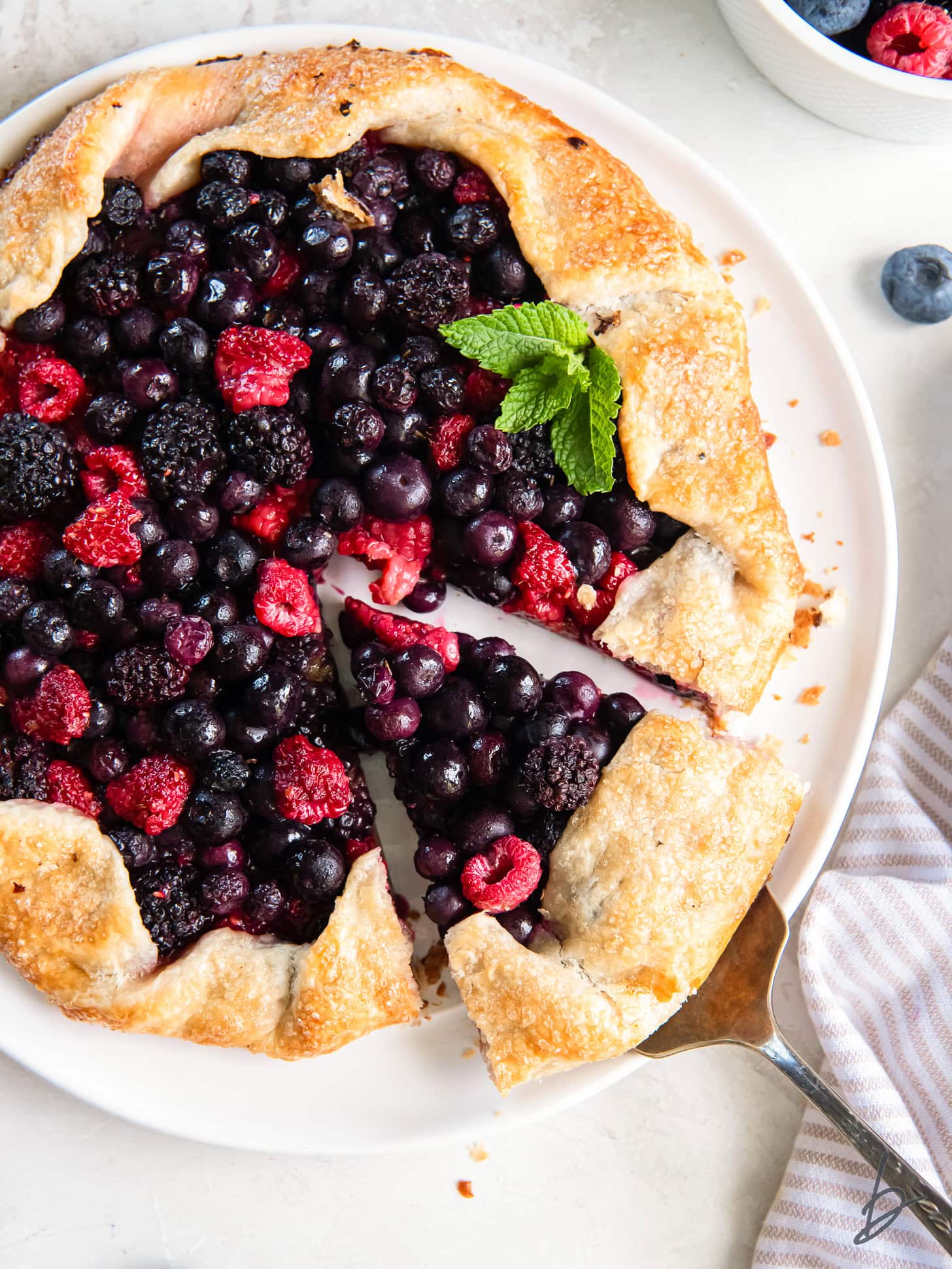 slice of berry galette being pulled away from the rest of the galette.