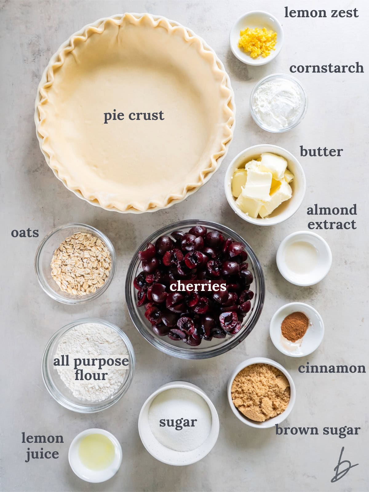 tabletop with bowls of ingredients to make cherry crumble pie.