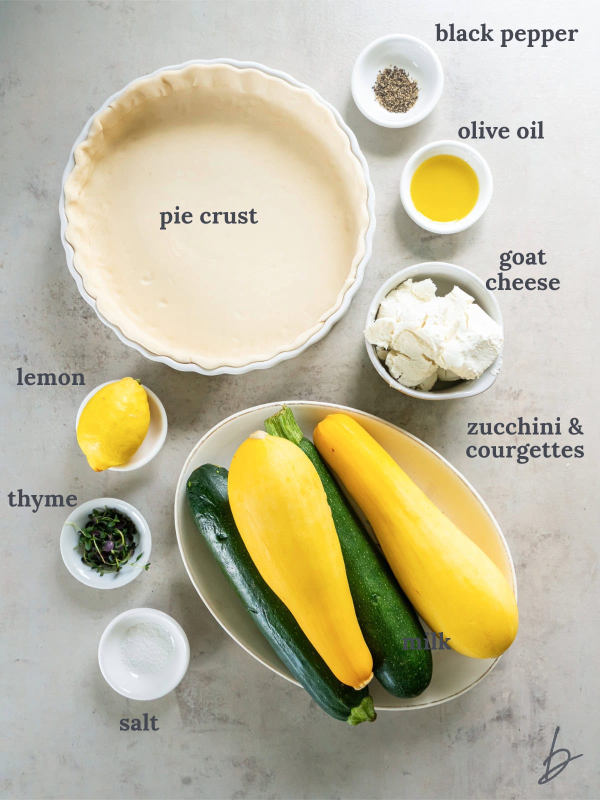 bowls of ingredients to make a zucchini tart with goat cheese.