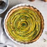 beautiful zucchini tart with concentric pattern of zucchini inside the tart.