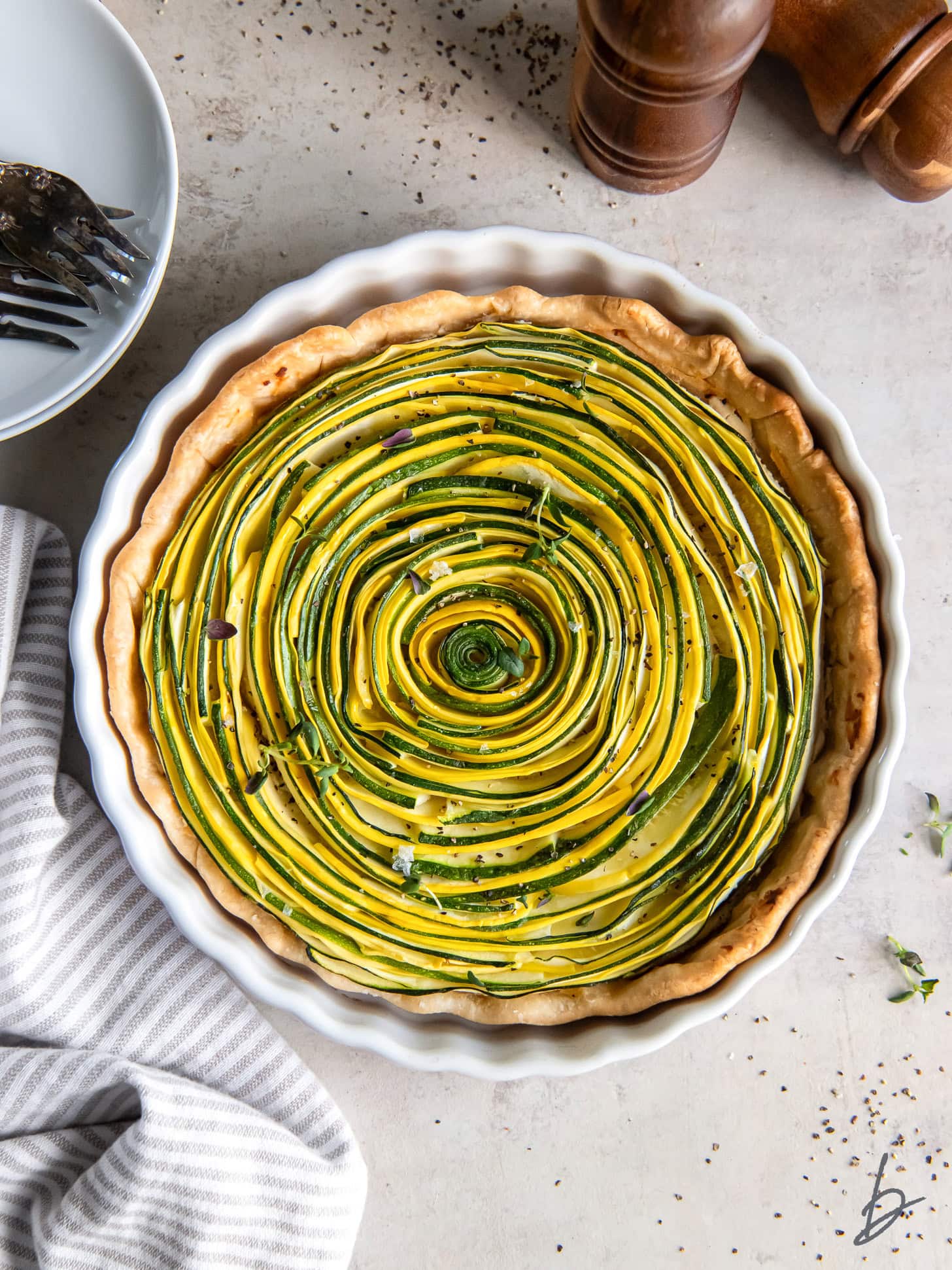 beautiful zucchini tart with concentric pattern of zucchini inside the tart.