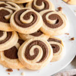 plate of chocolate pinwheel cookies in a pile.
