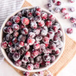 bowl of sugared cranberries on a tabletop.