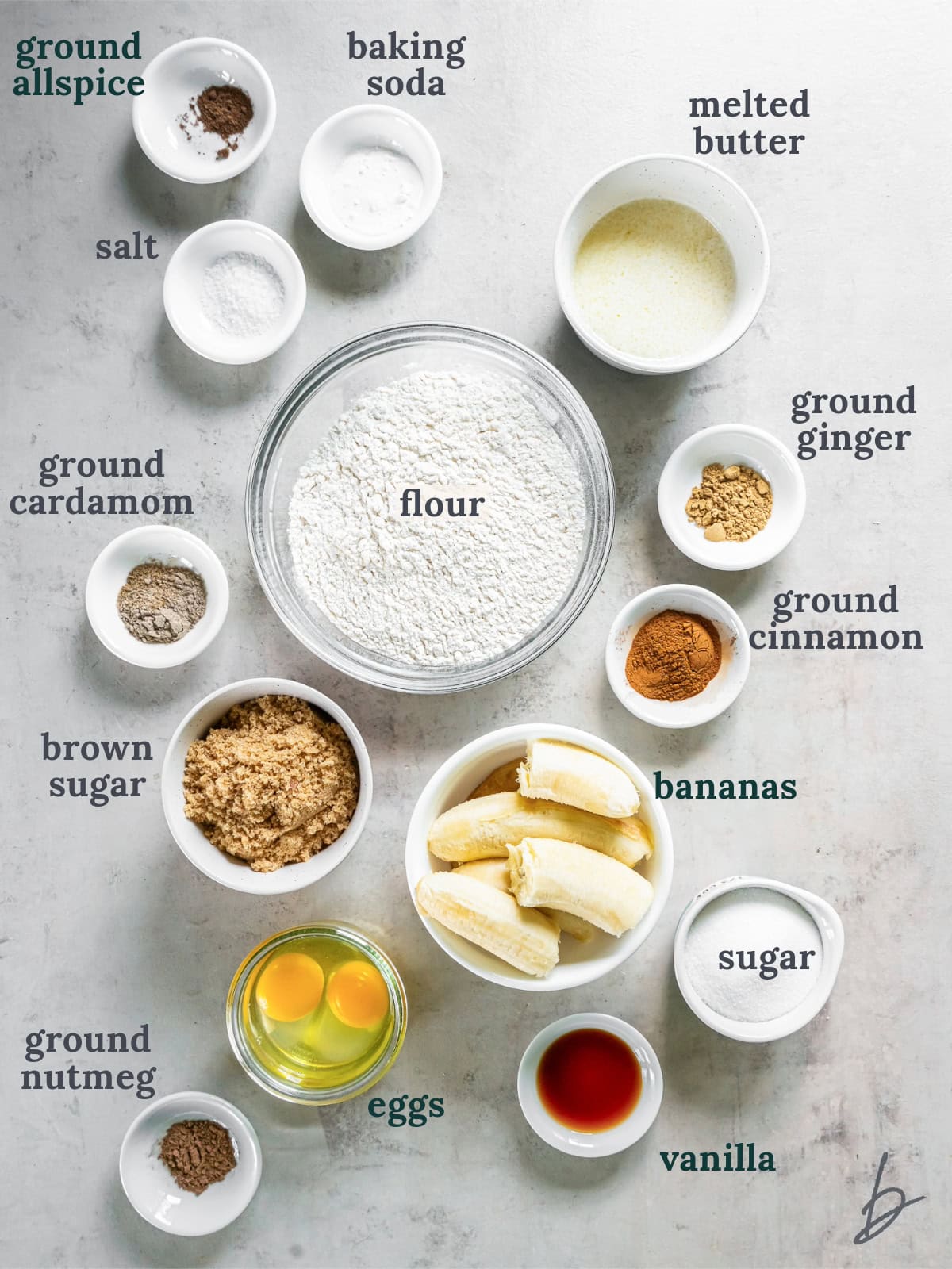 tabletop with bowls of ingredients to make chai banana bread.