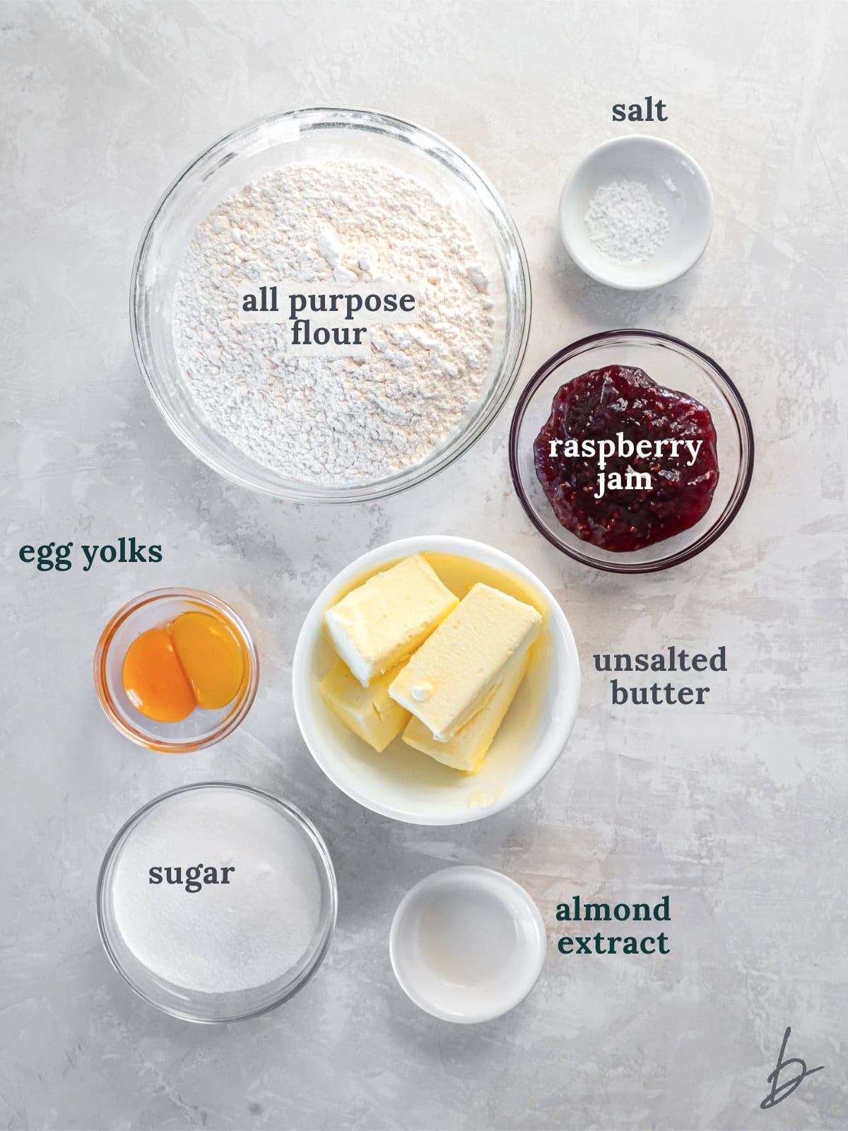 tabletop with bowls of ingredients to make jam heart cookies.