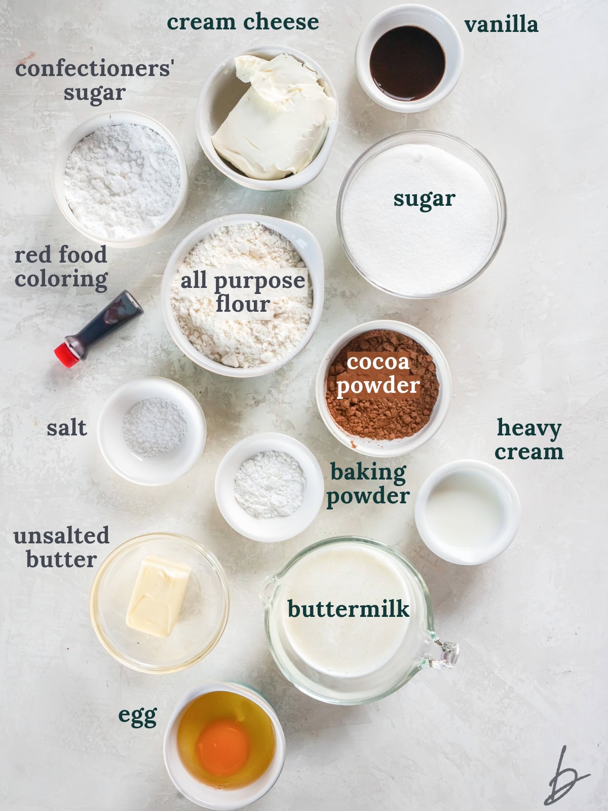 bowls of ingredients to make red velvet donuts with cream cheese icing.