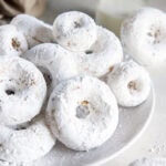 plate of homemade powdered sugar donuts.