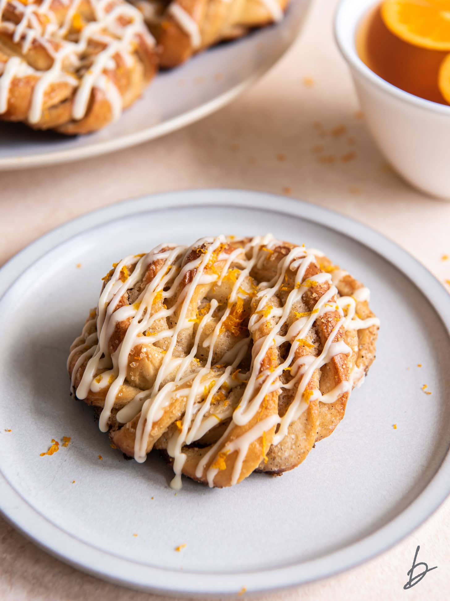 A cardamom roll on a white plate.