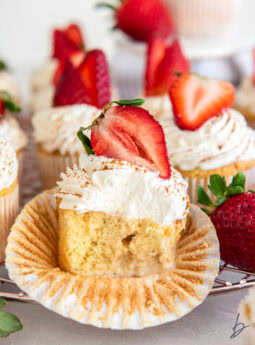 tres leches cupcake cut in half to show milk soaked filling.