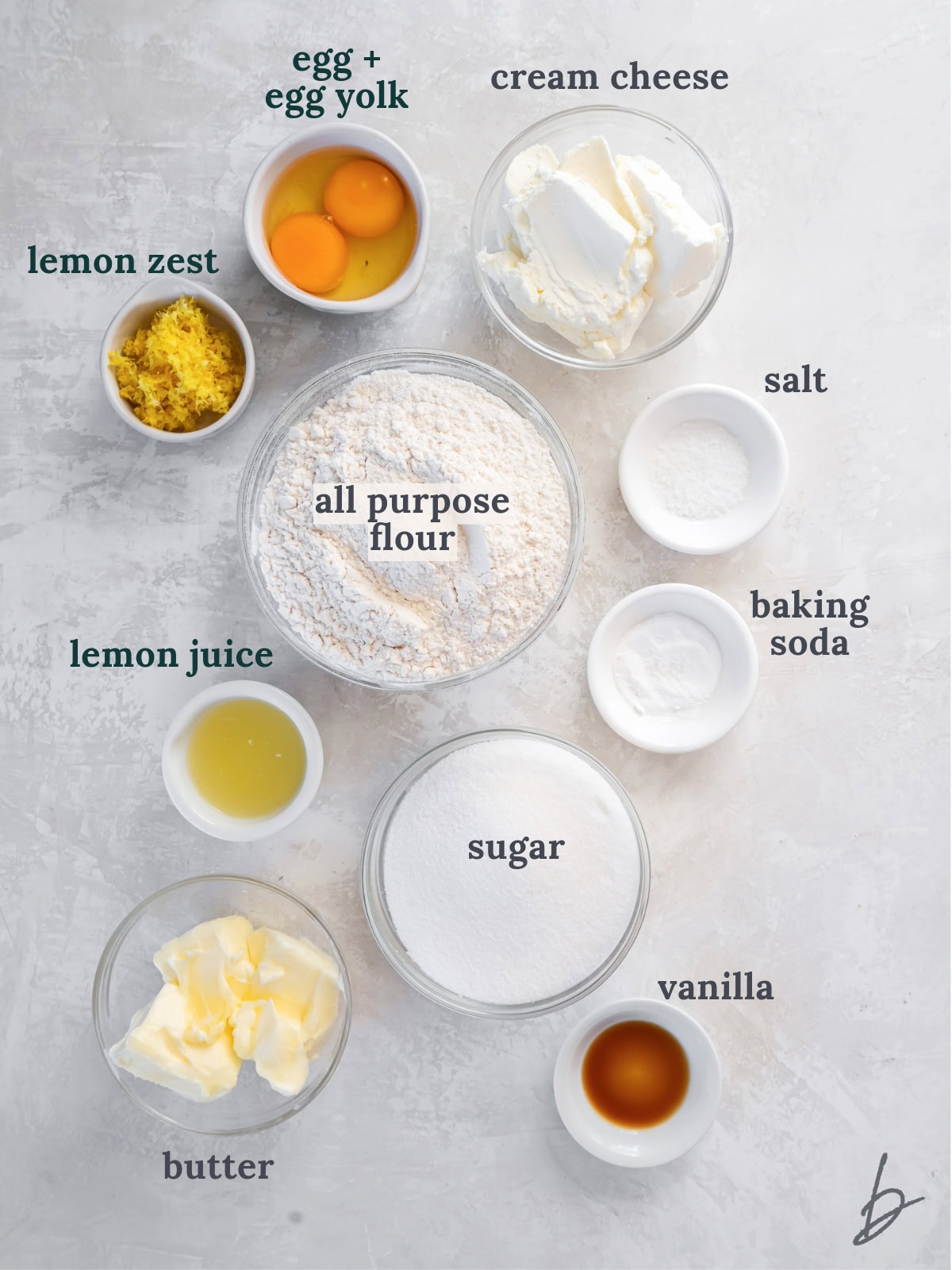 tabletop with bowls of ingredients to make lemon cheesecake cookies.