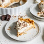 Slice of banoffee pie served on a white plate.
