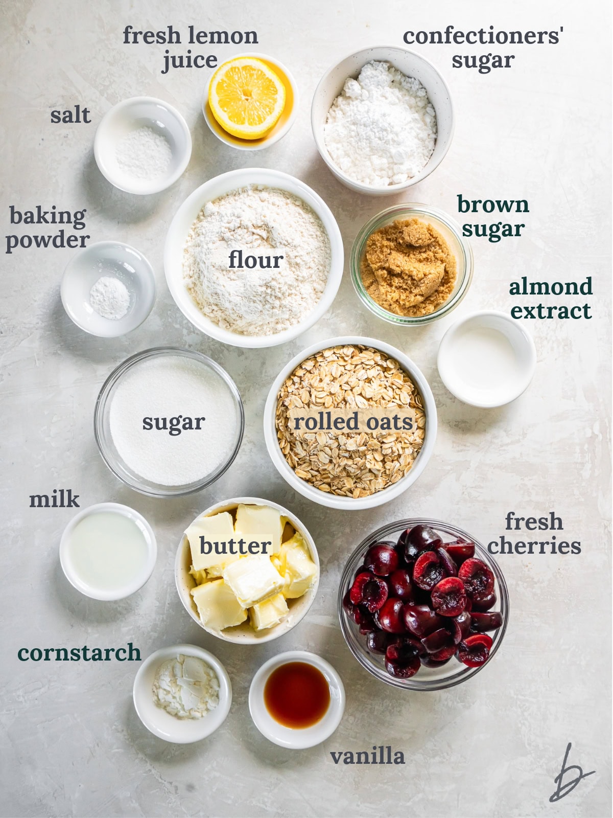 tabletop with bowls of ingredients to make cherry crumble bars.