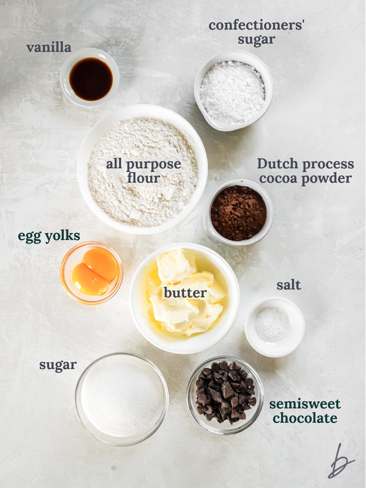 tabletop with bowls of ingredients to make chocolate icebox cookies.