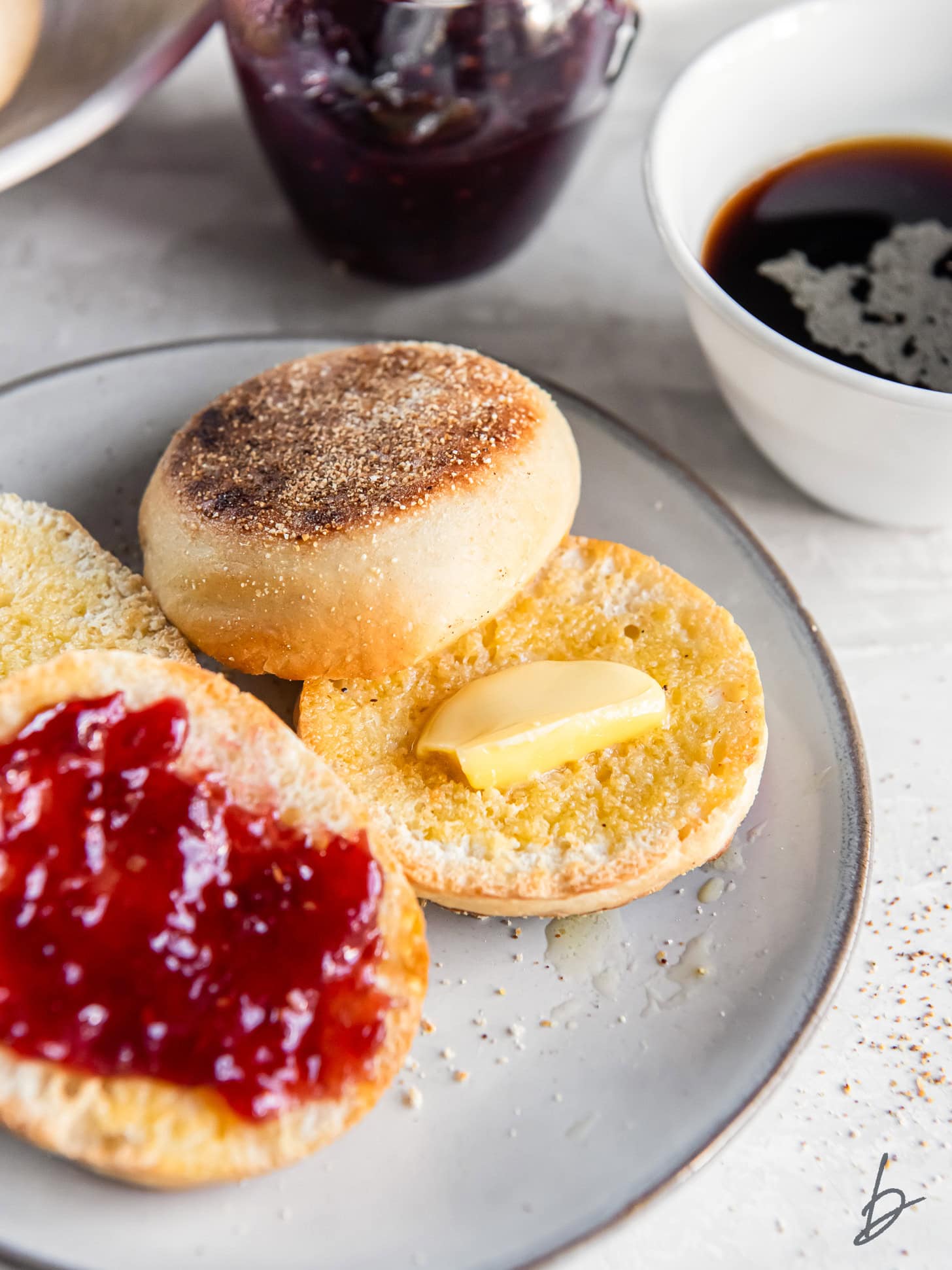 Homemade English muffins served with jam and butter.
