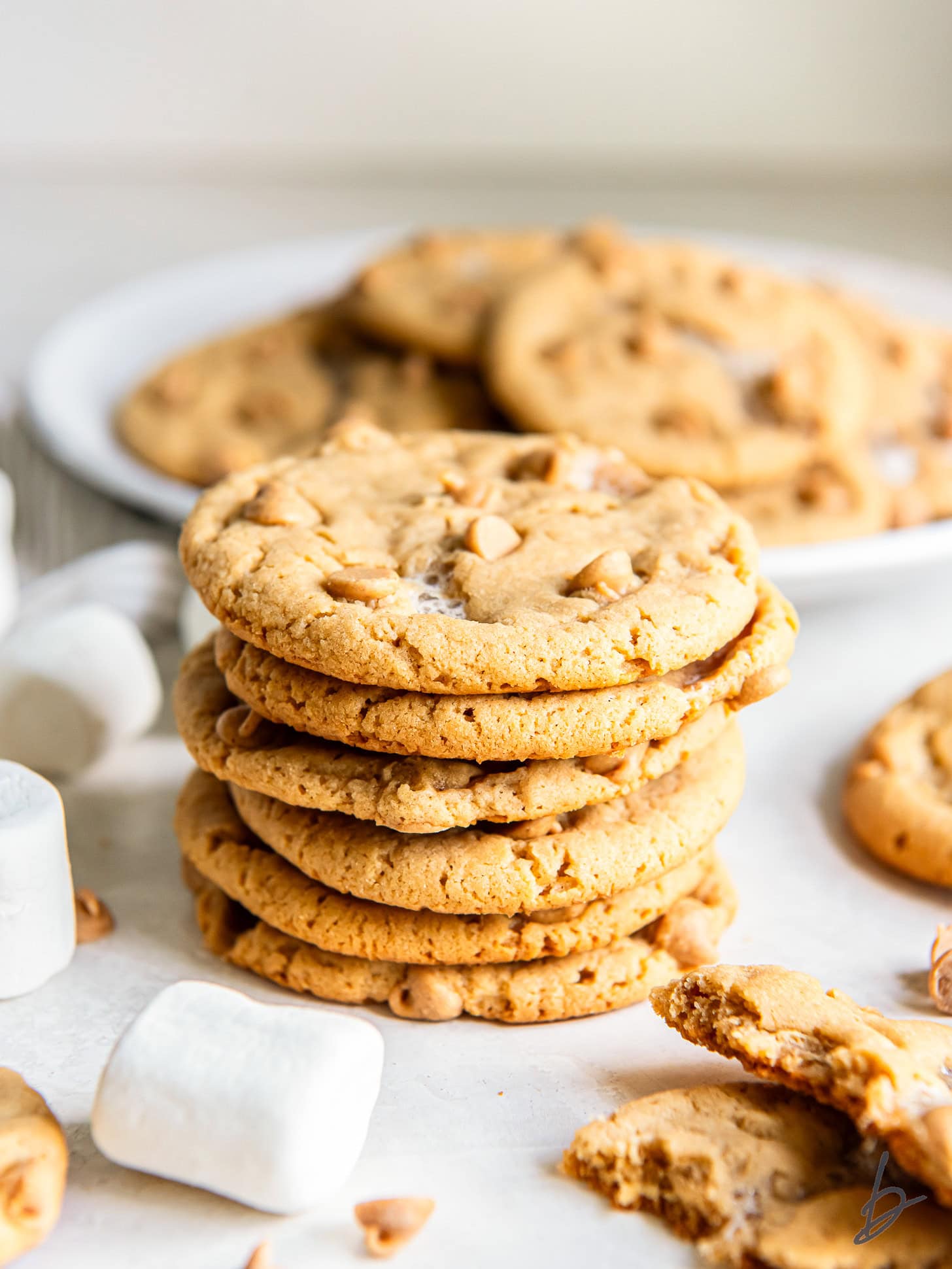 stack of fluffernutter cookies in front of a plate with more cookies.