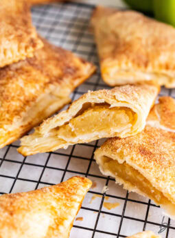 Apple turnovers on a wire cooling rack.