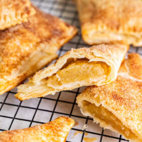 Apple turnovers on a wire cooling rack.