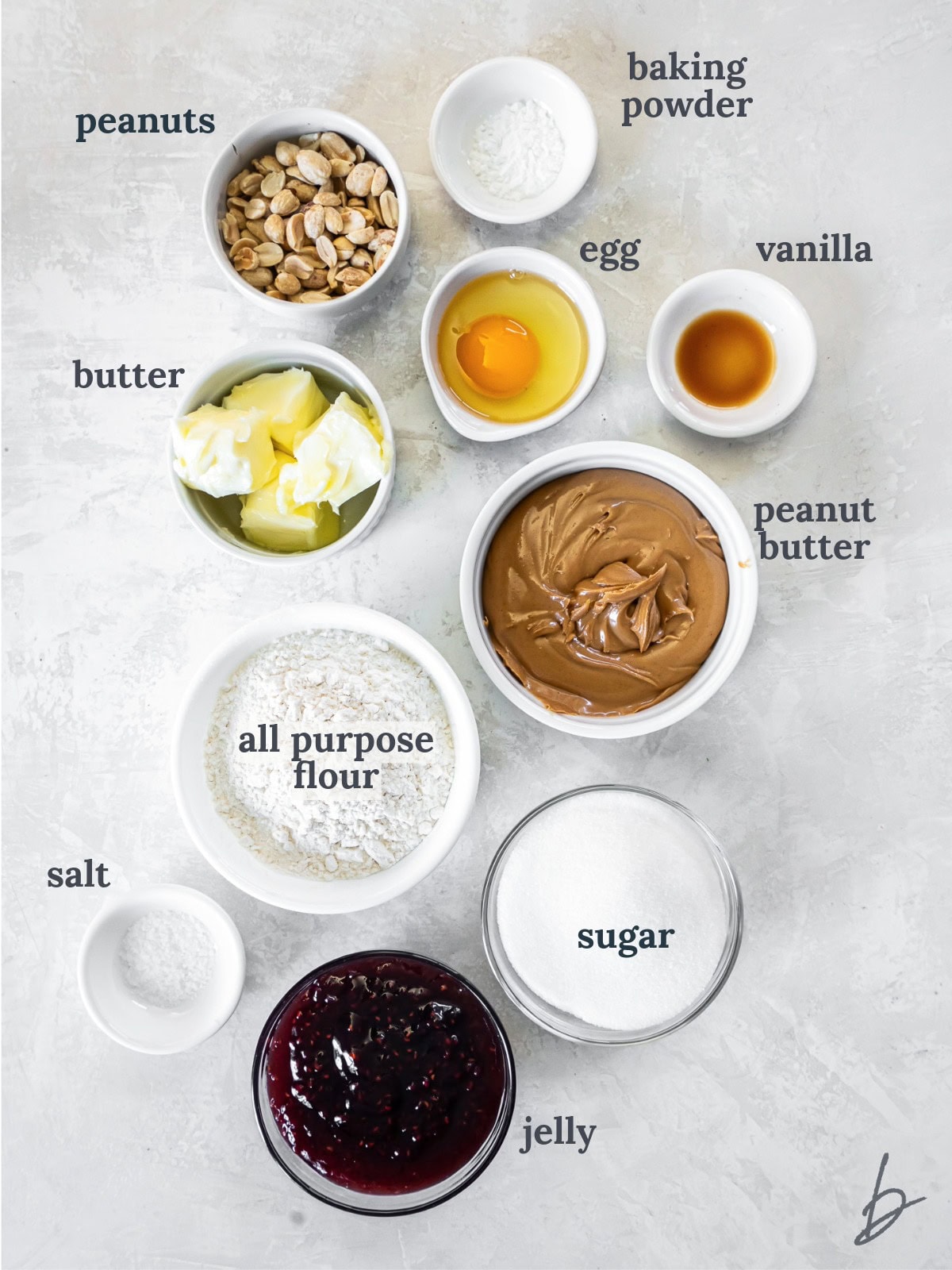 tabletop with bowls of ingredients to make peanut butter jelly bars.
