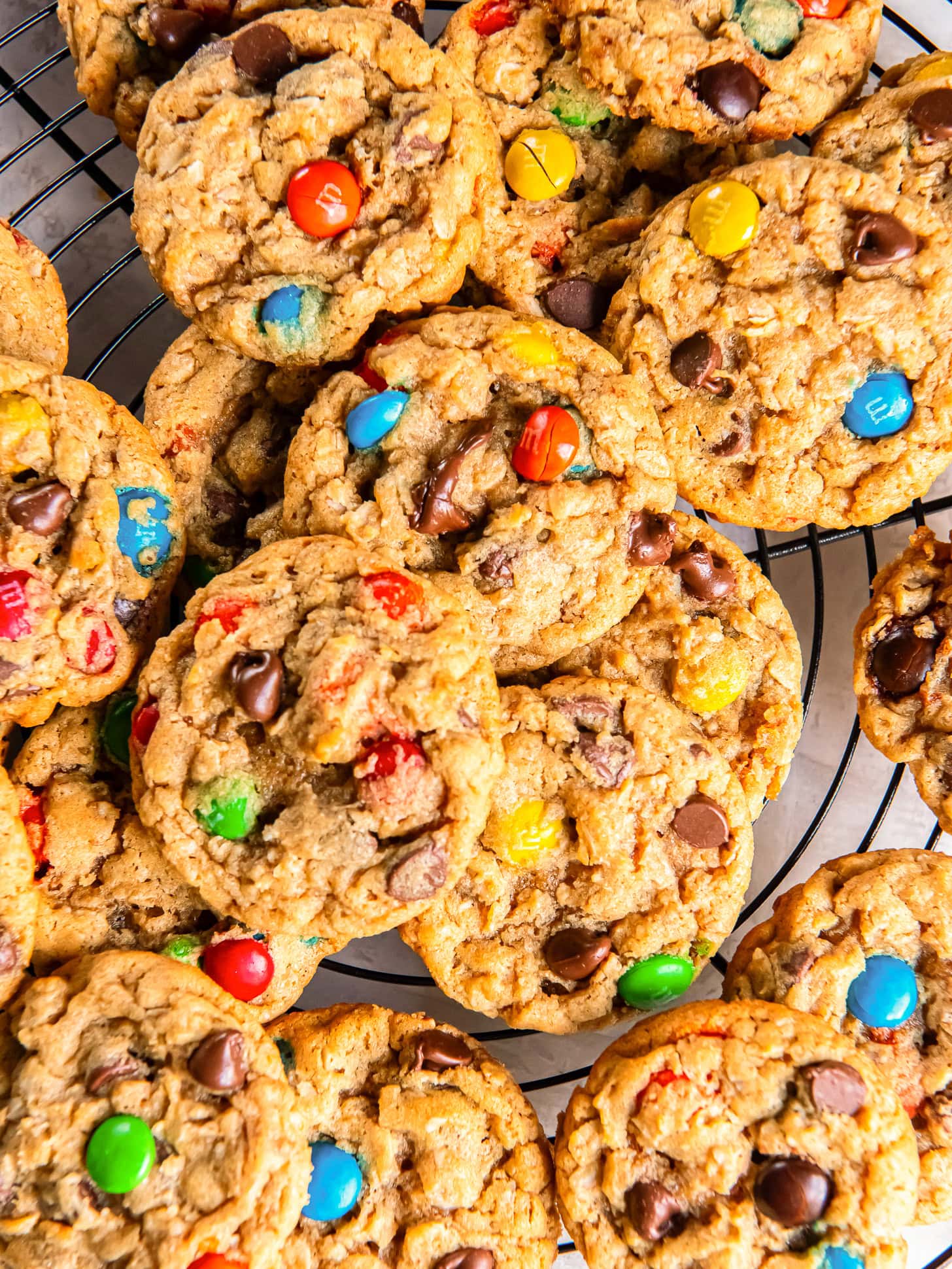 chewy monster cookies layered on top of each other.