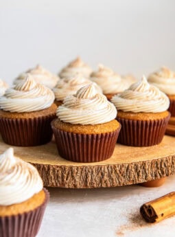 Spice cake cupcakes topped with a swirl of frosting.