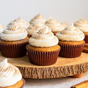 Spice cake cupcakes topped with a swirl of frosting.