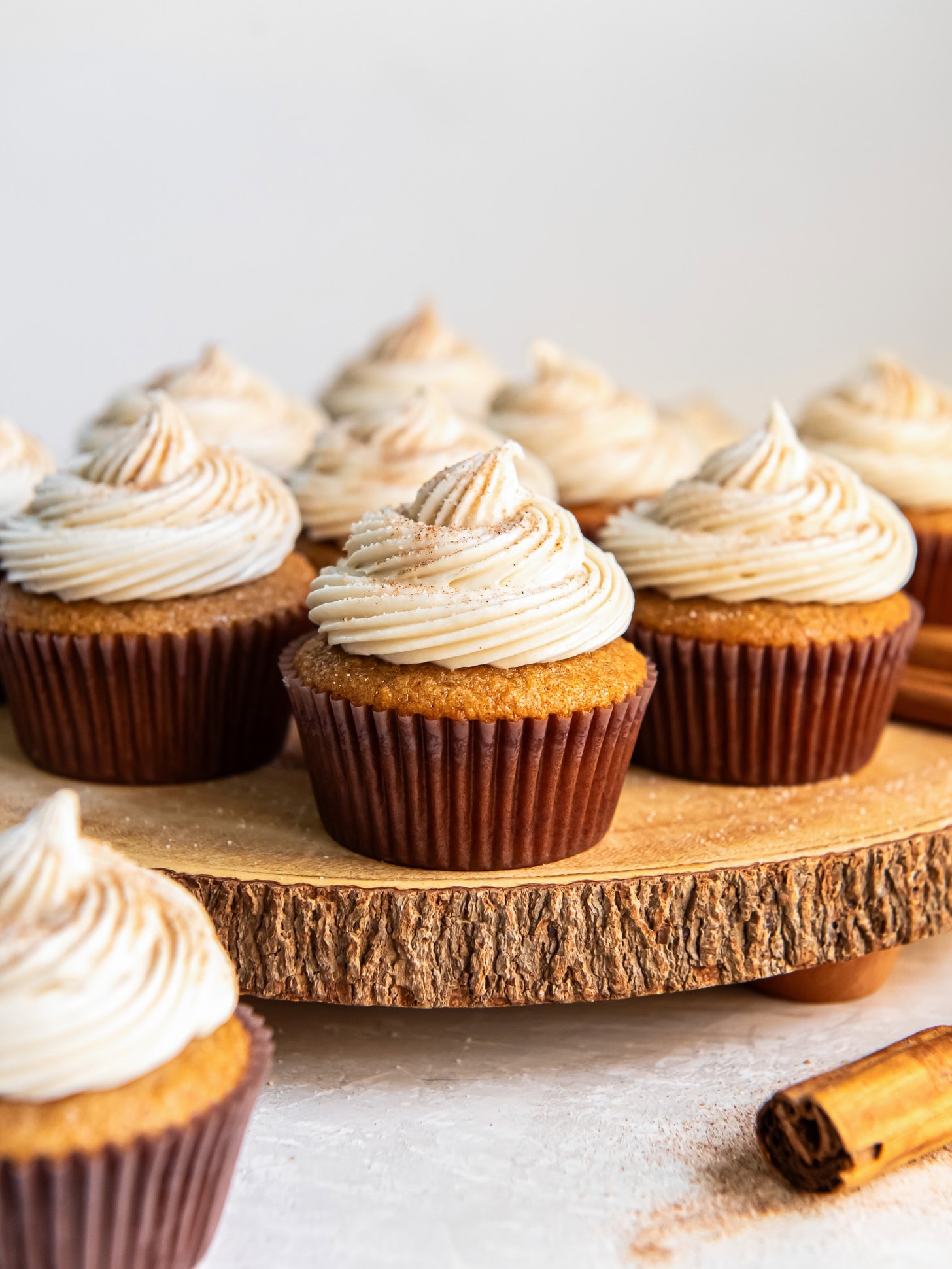 Spice cake cupcakes topped with a swirl of frosting.