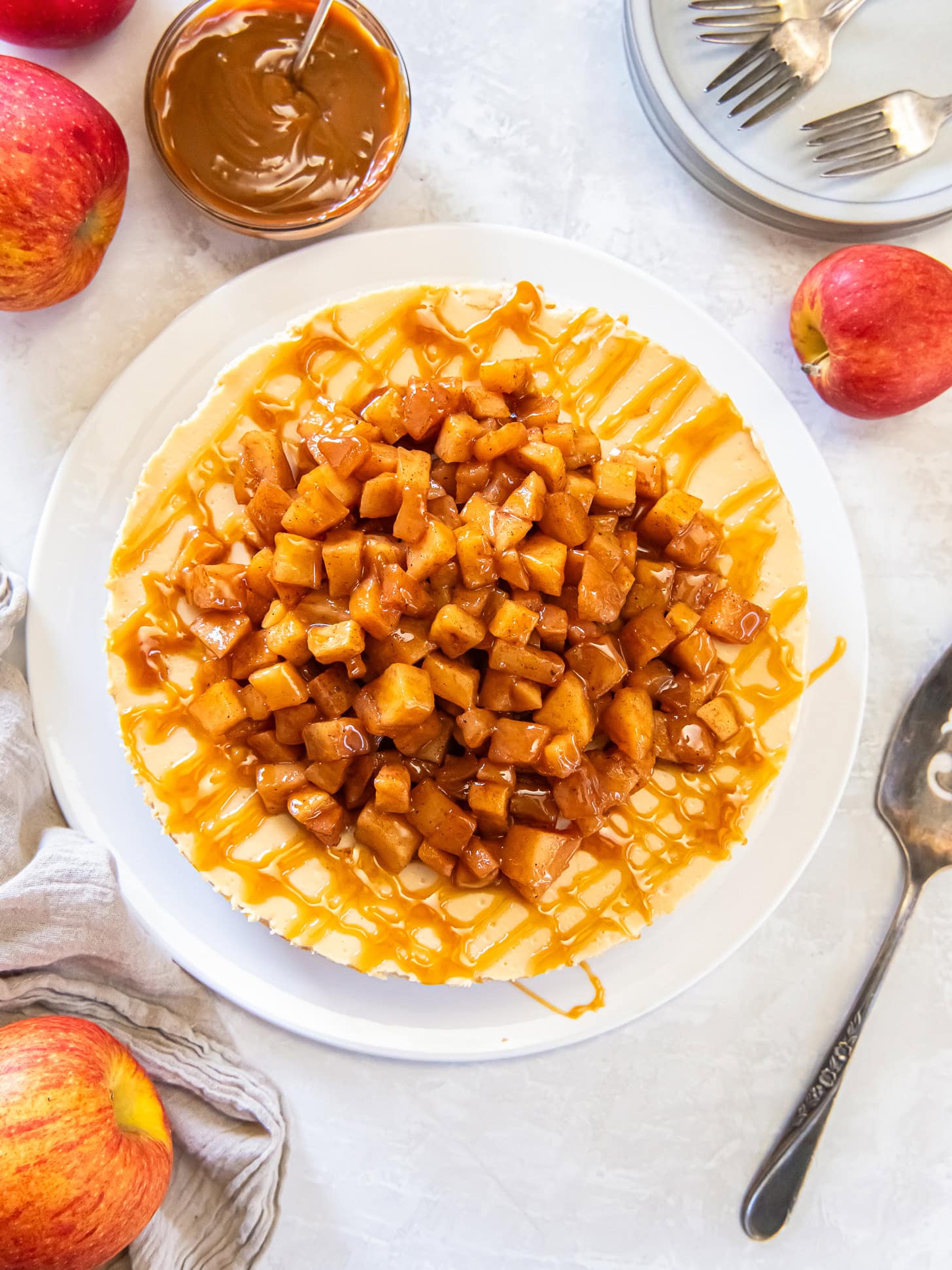 Cheesecake topped with cinnamon apples and caramel sauce.