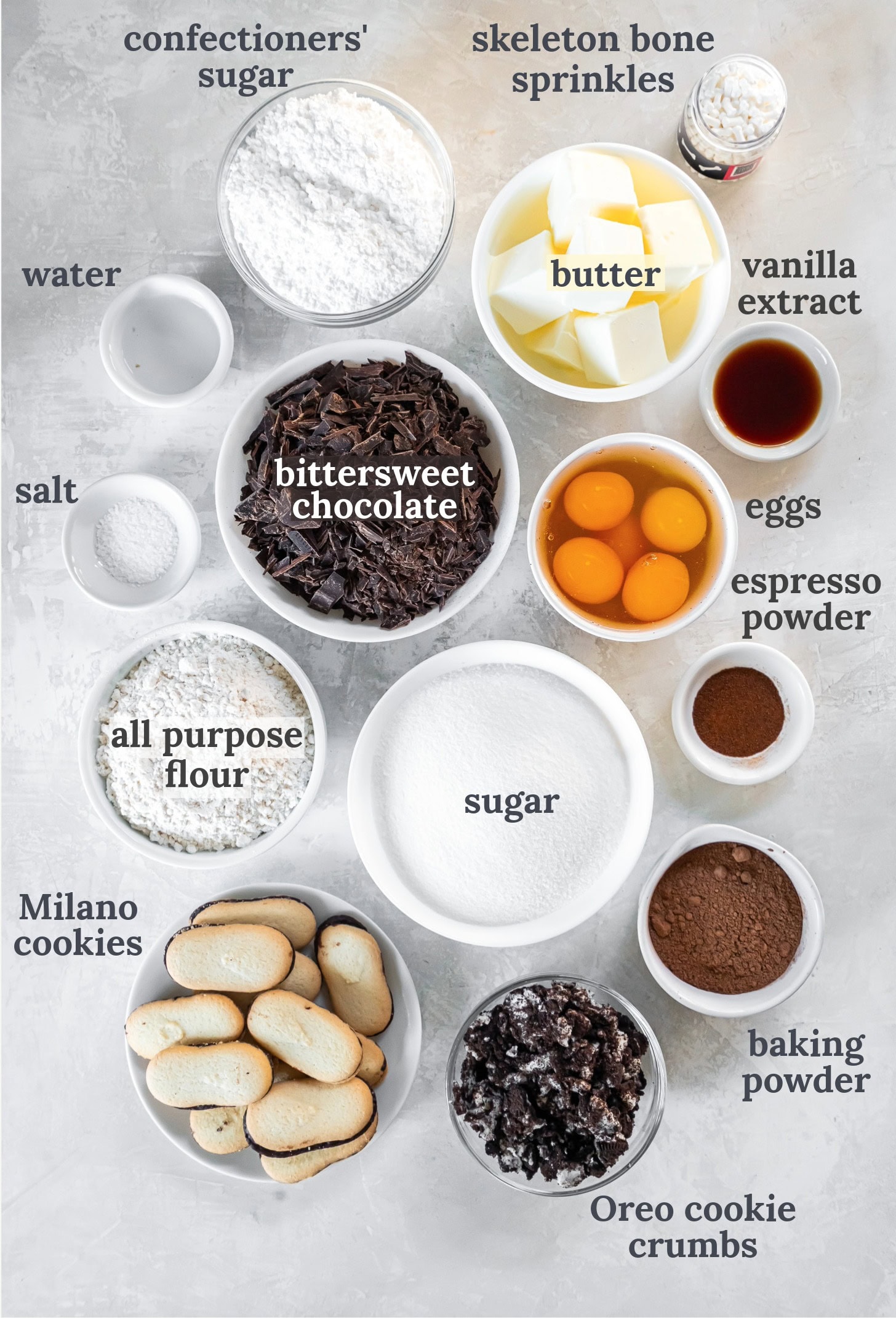 Bowls full of flour, sugar, chocolate, eggs, butter, cookies and Oreo cookie crumbs.