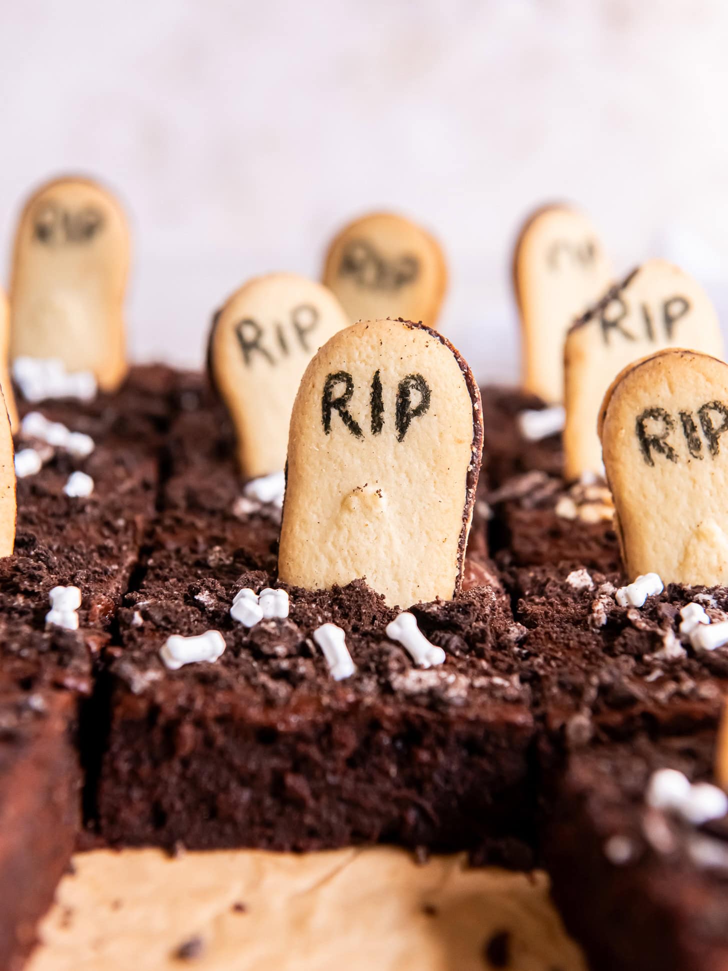 Slice of graveyard brownie in a pan.