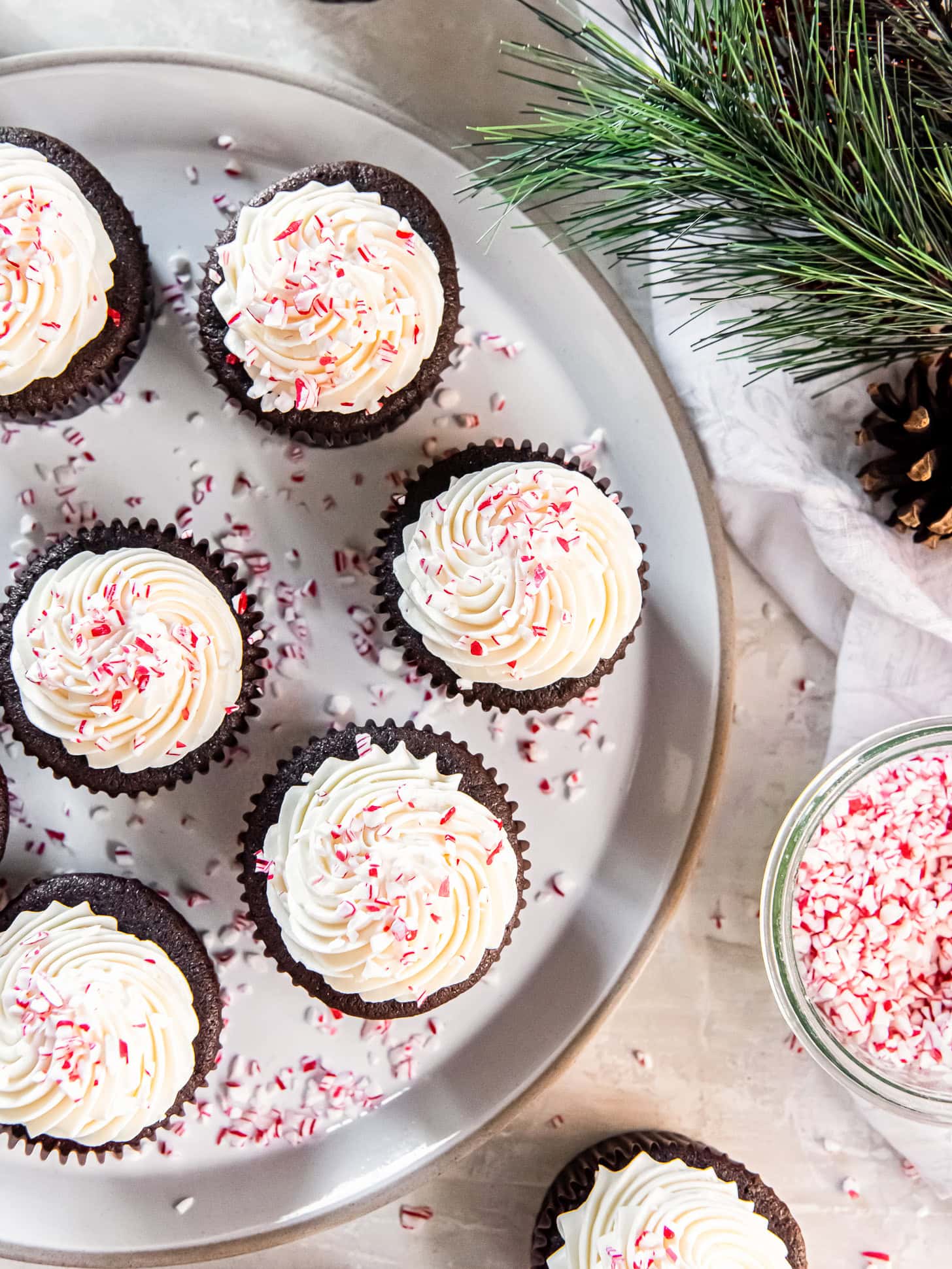 Chocolate peppermint cupcakes on a silver serving tray.