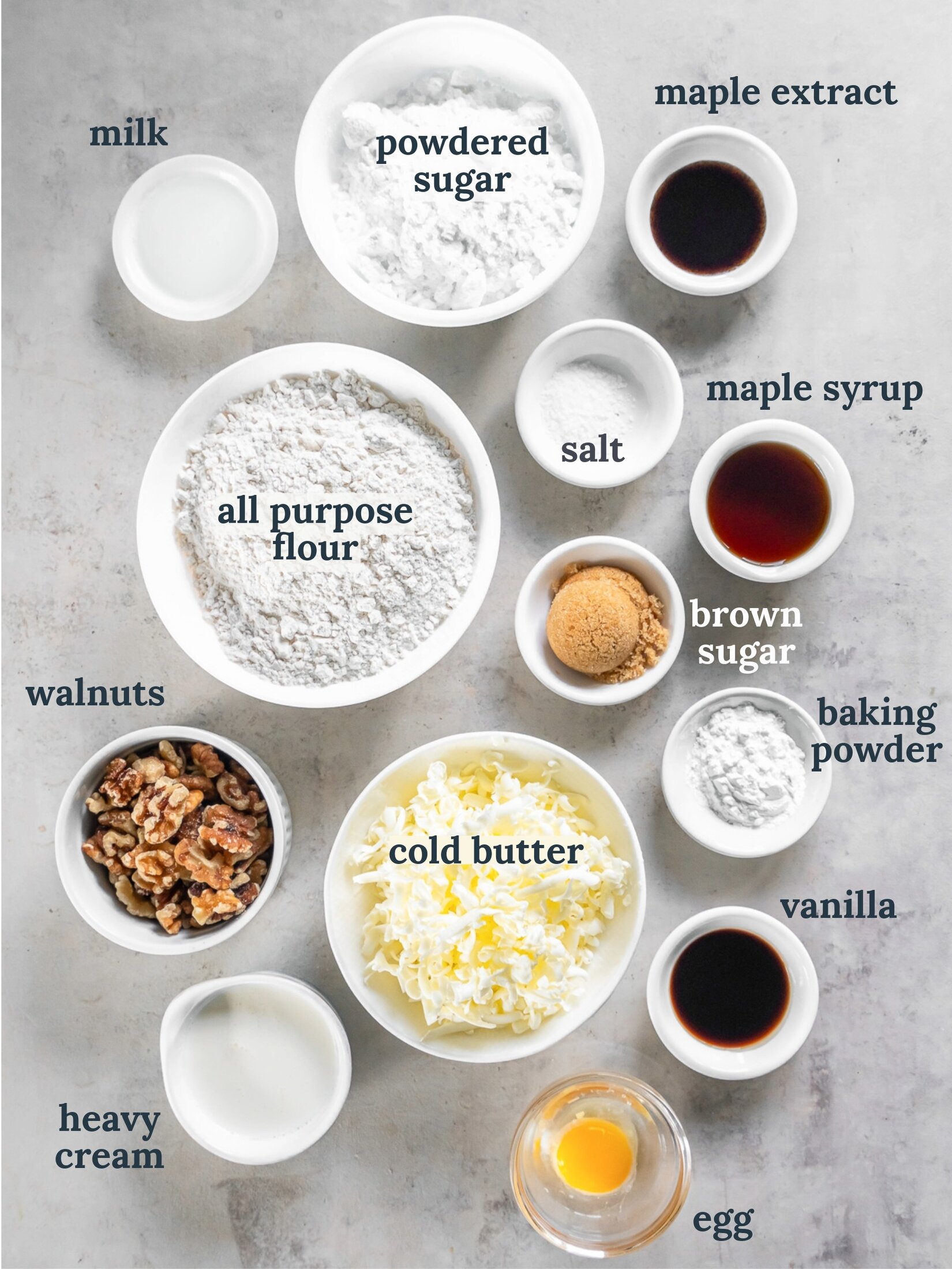 Small bowls with flour, cold butter, sugar, vanilla, walnuts and maple syrup. 