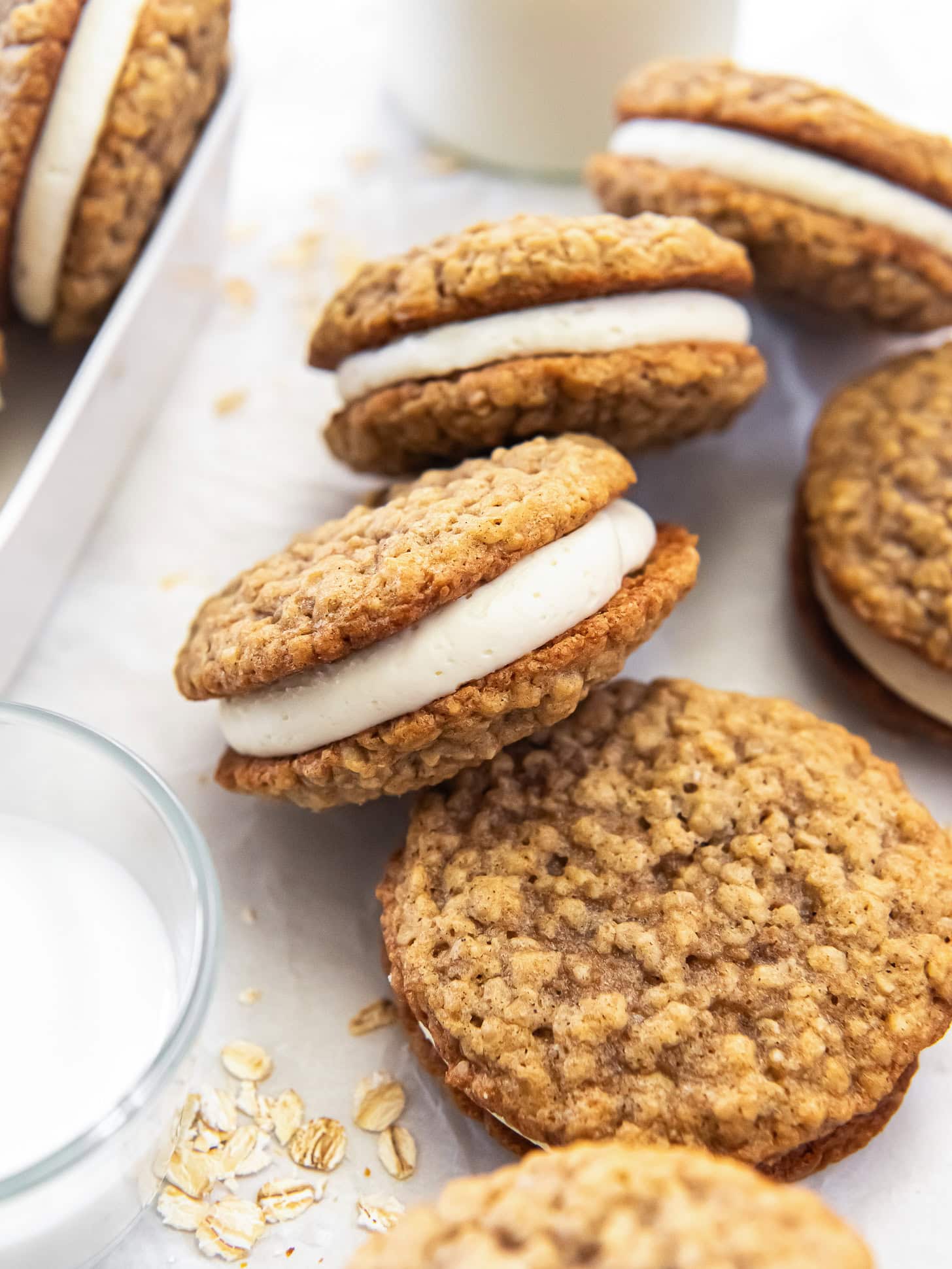 Oatmeal cream pie cookies served with a glass of milk.