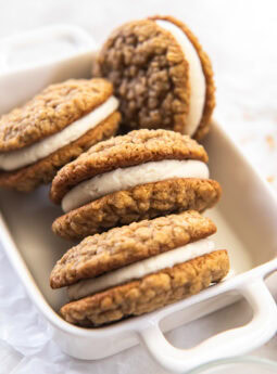 Oatmeal creme pies stacked in a white dish.