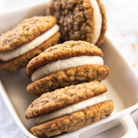 Oatmeal creme pies stacked in a white dish.