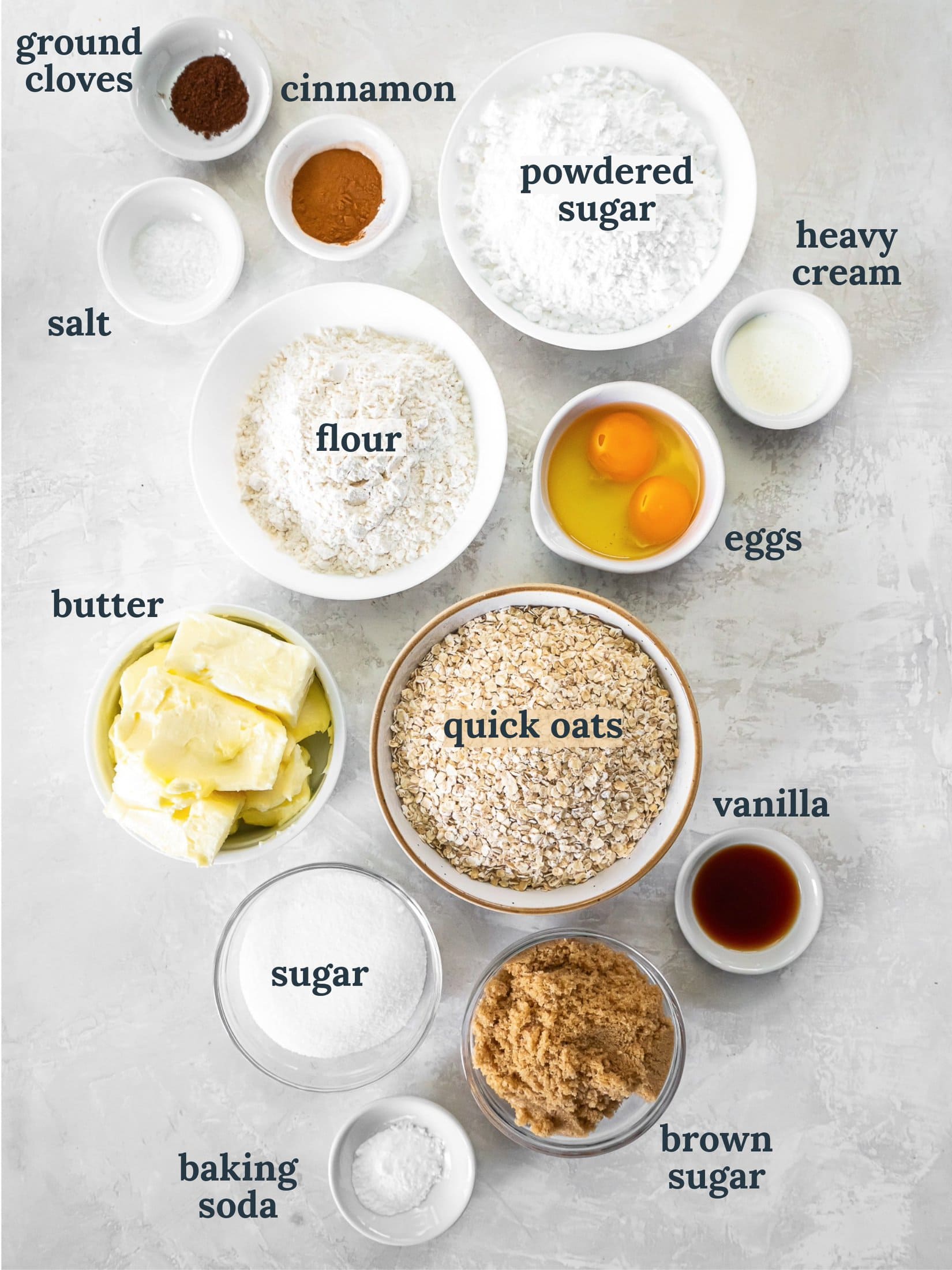 Bowls with quick oats, sugar, flour, powdered sugar, eggs, vanilla and cinnamon.