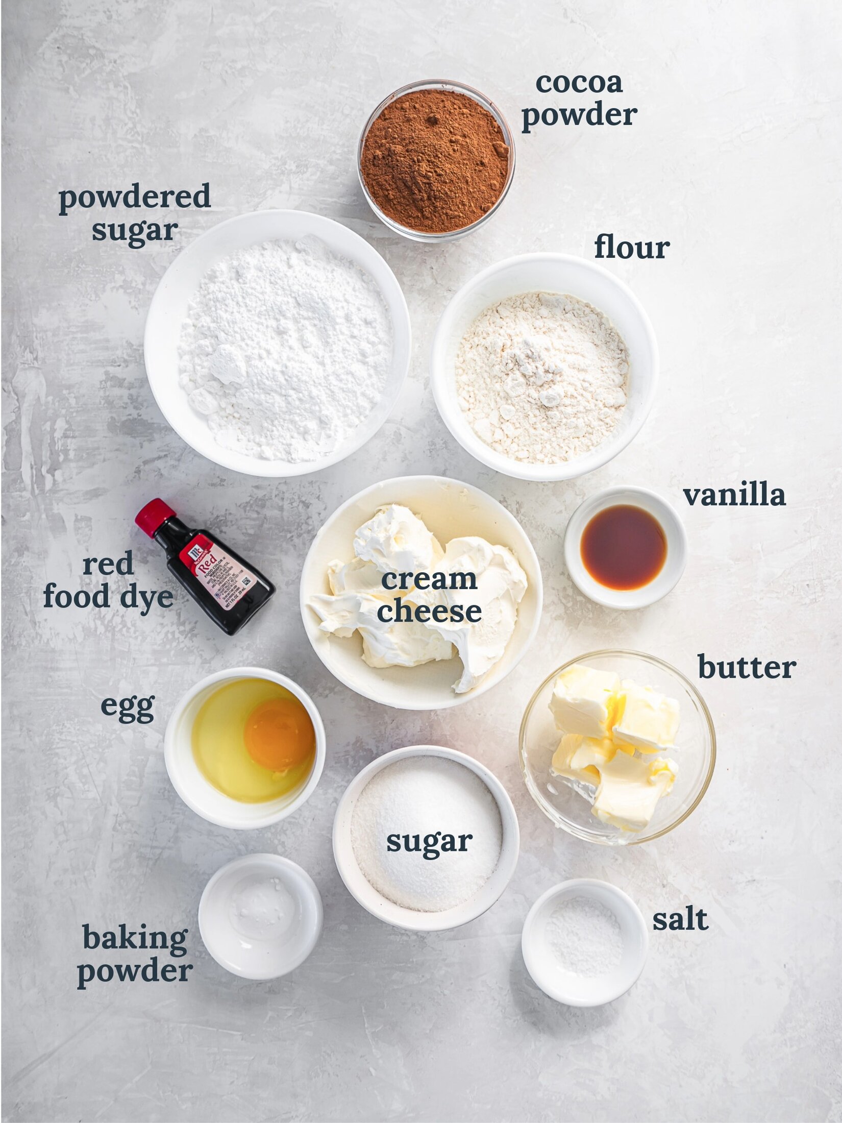 Small bowls with sugar, flour, cream cheese, vanilla, butter and salt.