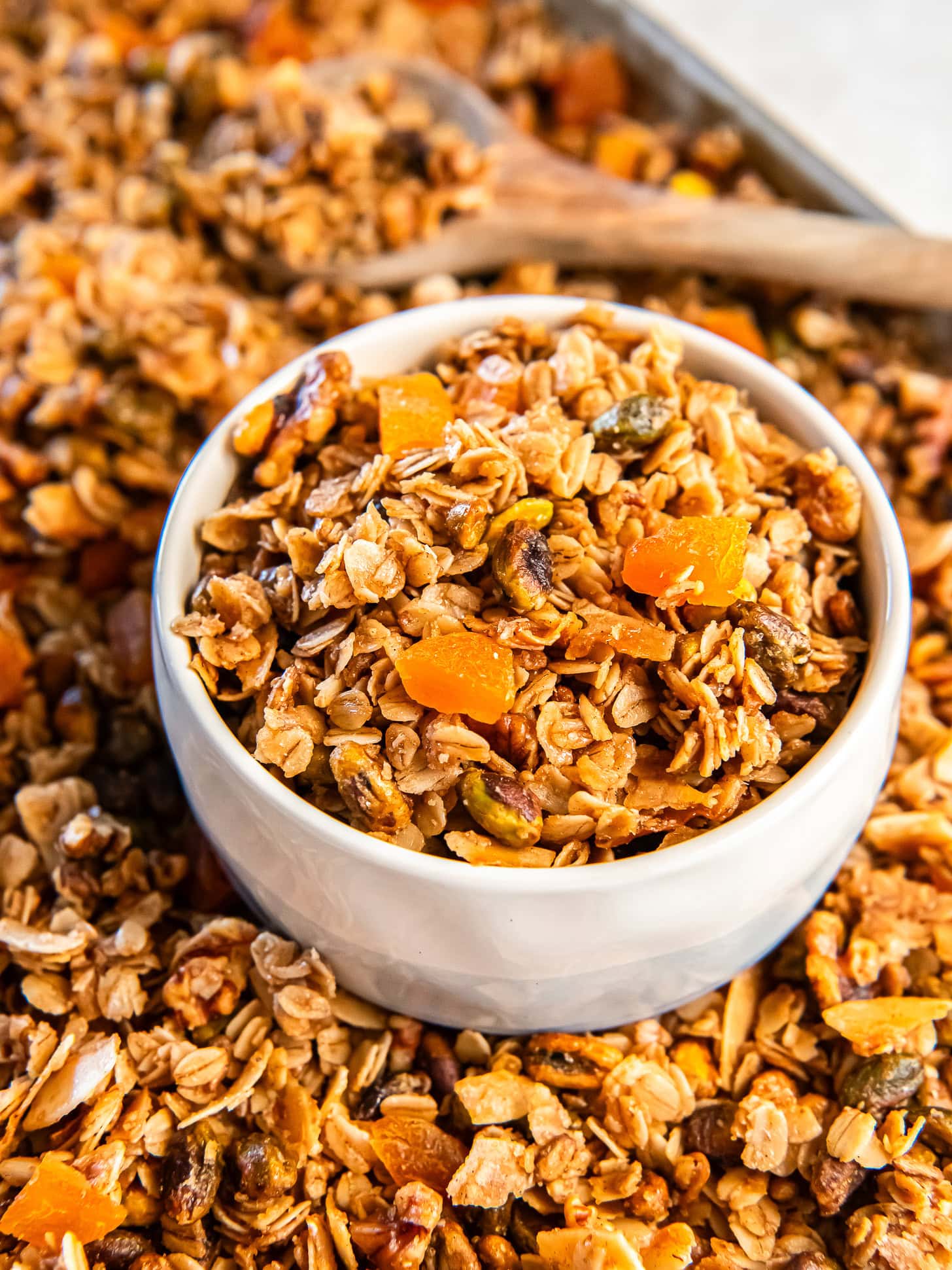 White bowl filled with a nutty apricot granola.
